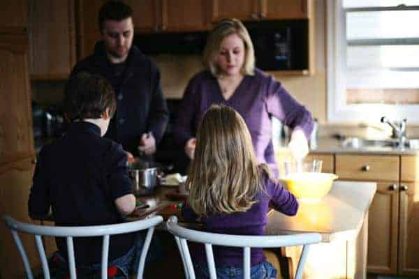 family picture in the kitchen preparing the Christmas Pudding