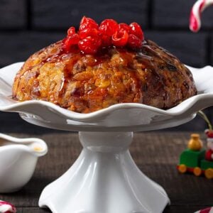 close up carrot Christmas Pudding on a white ceramic cake holder