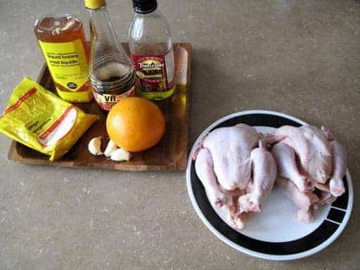 Honeyed Cornish Game Hens Marinade Ingredients all in a wood tray, 2 pieces Cornish game hens in a plate