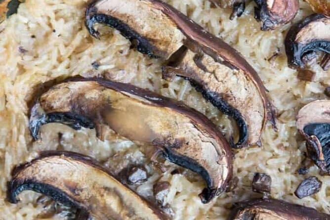 close up of Rice & Mushroom Casserole with large baked mushrooms on top