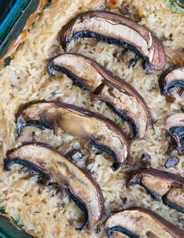 close up of Rice & Mushroom Casserole with large baked mushrooms on top