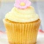 Lemon Buttercream Frosting and pink icing flower on top of lemon cupcake
