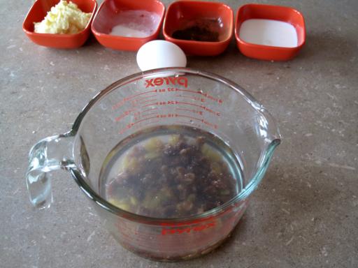 Pyrex measuring cup with some water and raisins
