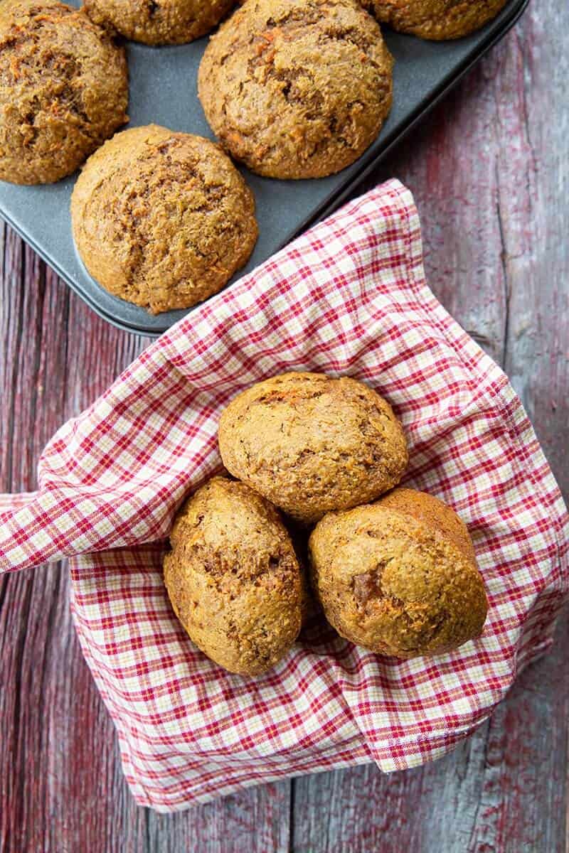 Carrot Muffins on muffin tins and in red checkered cloth