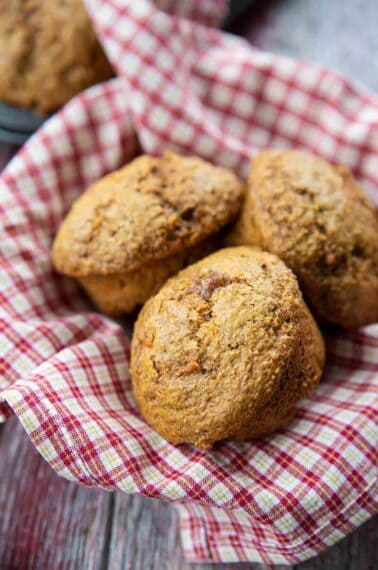 close up of Carrot Bran Muffins on a red checkered cloth