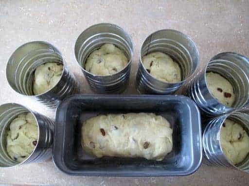 top down shot of Babka dough in coffee tins and loaf pan