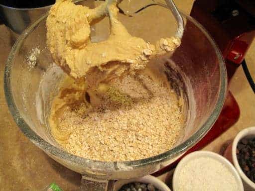 adding the oats to whisked ingredients