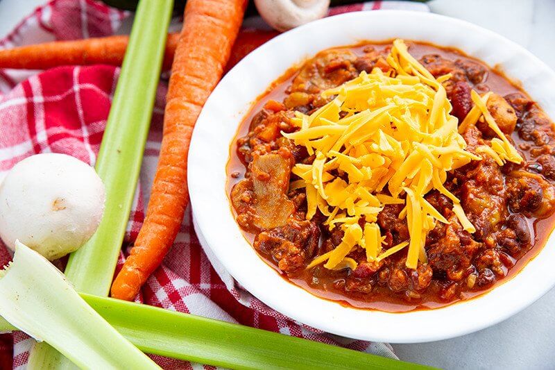 Kitchen Sink Chili with shredded cheese on top