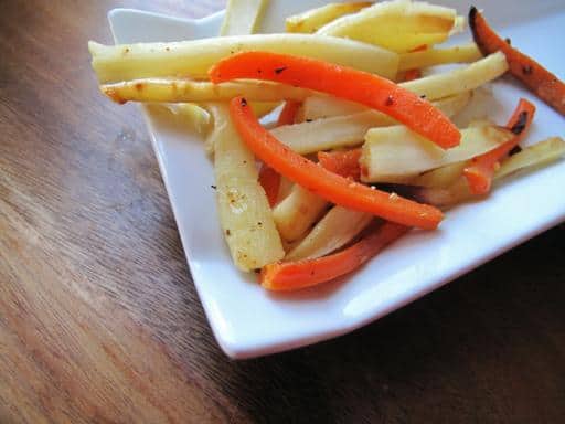 Roasted parsnips and carrots in a white plate