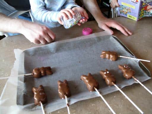Chocolate coated bunny peeps in a baking sheet with parchment paper