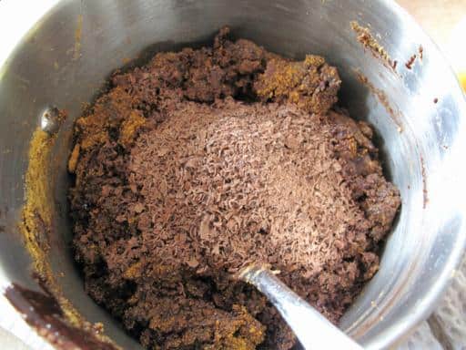 Adding the graham crumbs and coconut to melted mixture in a pot