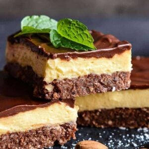 close up 3 pieces nanaimo bars, mint leaves and walnuts