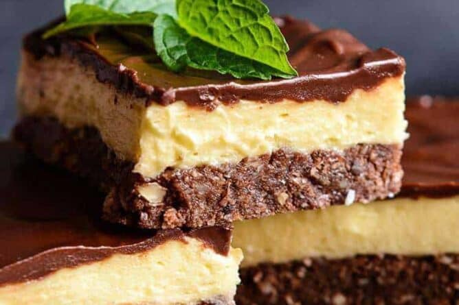 close up 3 pieces nanaimo bars, mint leaves and walnuts
