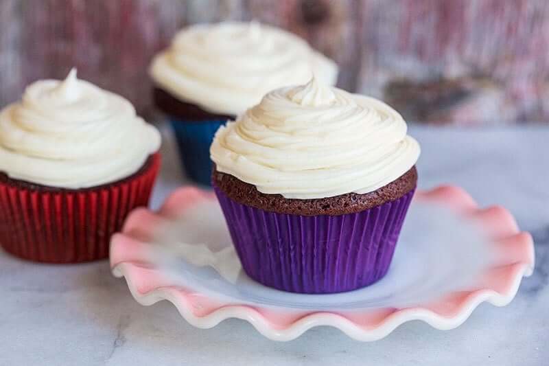 Red Velvet Cupcakes with Cream Cheese Buttercream Frosting in red and blue cupcake liners