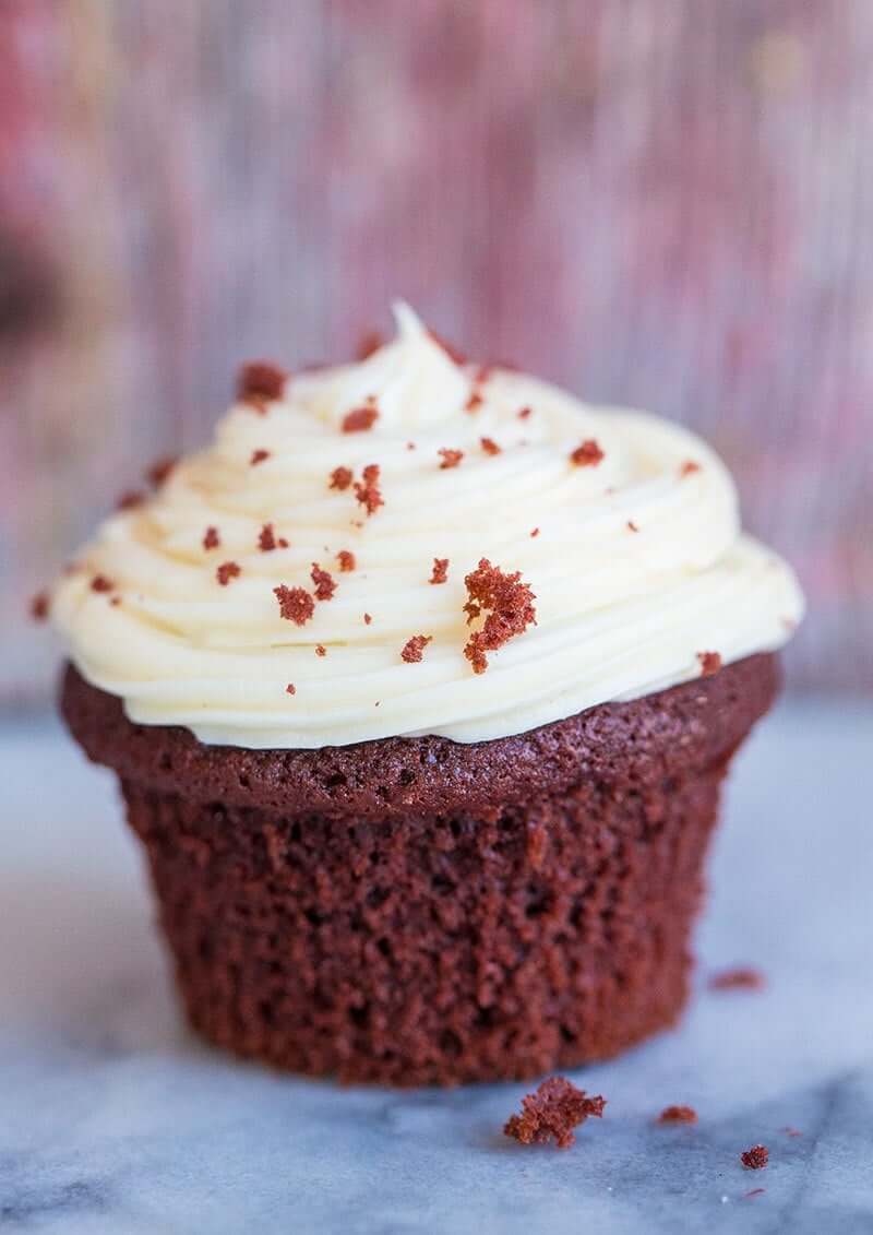 Red Velvet Cupcake with cream cheese frosting removed from cupcake liner