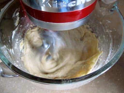 Mixing the butter and sugar, whipping the eggs and vanilla in a mixer for Chocolate Chunk Hazelnut Cookies a