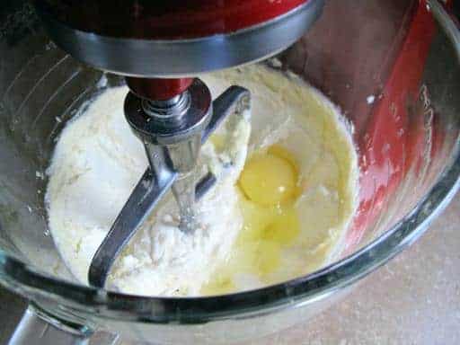 Adding the egg into the butter/sugar mix in the mixer