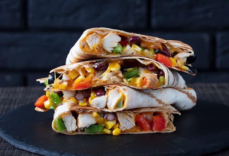  stack of Quesadillas in a large black serving plate