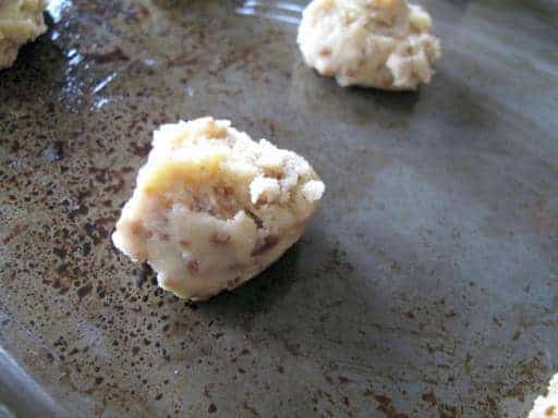 a well greased cookie sheet with rounded teaspoon of Toffee Bit Cookie dough