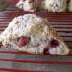 close up of Strawberry Yogurt Scones in red cooling rack showing the inside of it