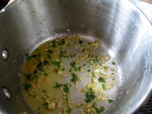 simmering the sauce in the pot with lemon juice, parsley, capers,wine and zest