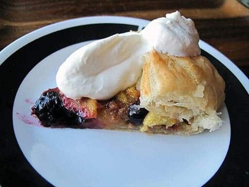 Simple & Easy Peach Blueberry Galette topped with whipped cream