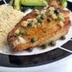 close up of Pan Seared Halibut on a plate with couscous and vegetables