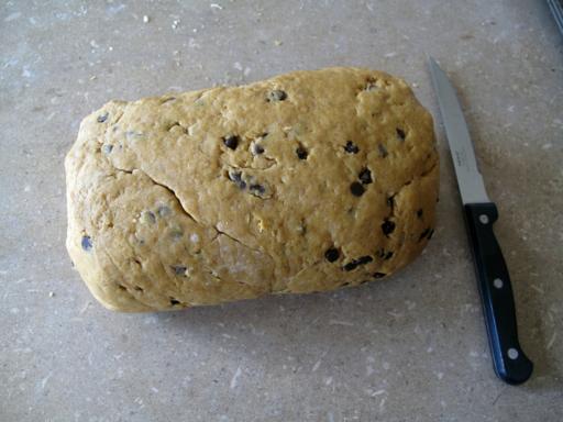rolled and shaped like a log Pumpkin Spice Scones dough and a knife beside it