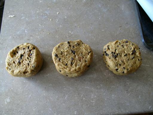 log like dough cut into three equal pieces in a parchment paper
