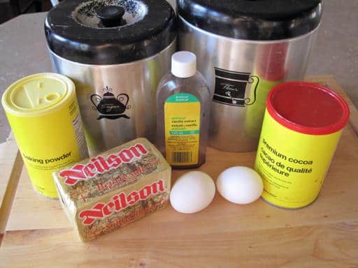 Ingredients Needed in making Chocolate Sugar Cookies all ready in a wooden board