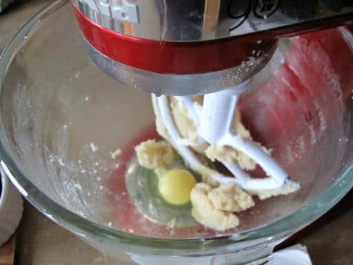 beating the egg and vanilla with creamed butter and sugars in a mixer