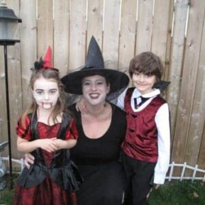 Mom and two kids wearing their halloween costumes