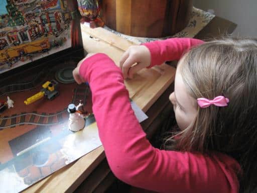 little girl fixing the lego set