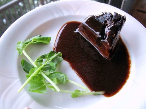 a serving of Bison short rib in a white plate