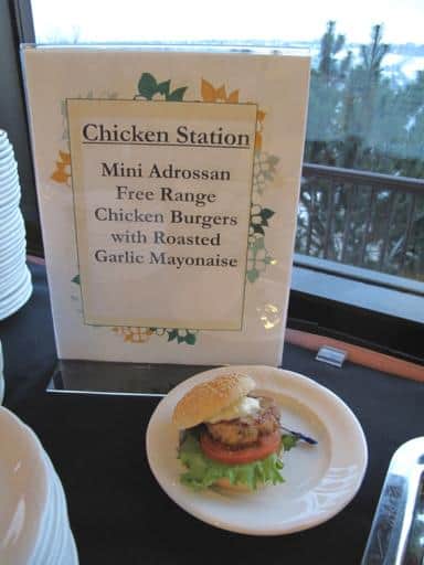 chicken station signage with a serving of chicken burger in a white plate