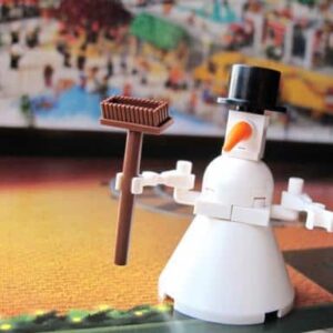 snowman lego holding a broom