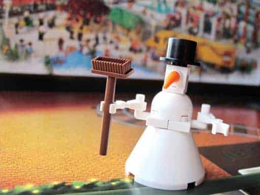 snowman lego holding a broom