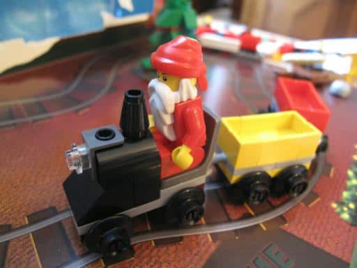 Close up of Santa with the yellow and red train cars lego