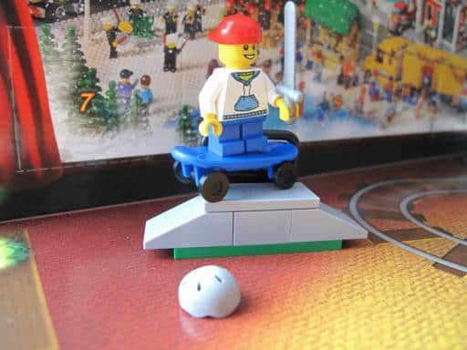 boy riding the skateboard on the ramp wearing red cap lego