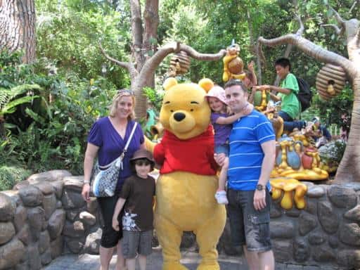 group photo of family at Disney with Pooh