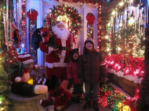kids inside the Maisie's Magical Christmas house with Santa figure on their back