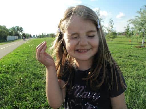 little girl closed her eyes cause of the dandelions she blew