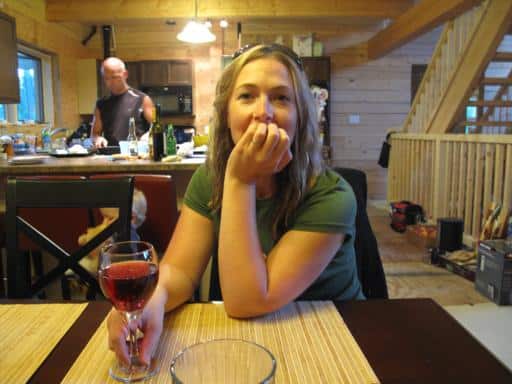 lady sitting in the table holding, her glass of wine 