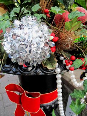 glittery Christmas ball with string of red and white beads