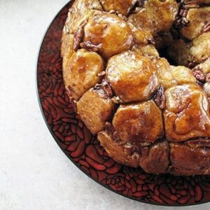 close up of whole Monkey Bread in a red plate with rose design