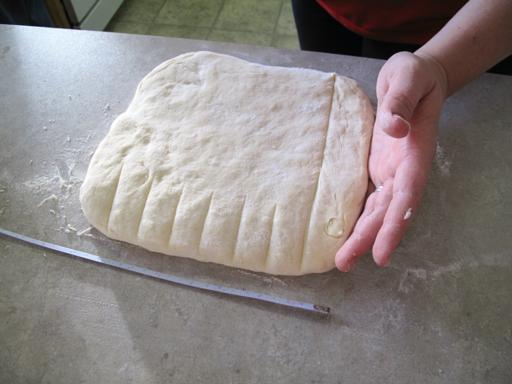 8x8 square of monkey bread dough ready to be cut