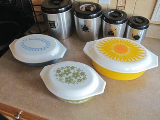 three casserole dish with cover and set of stainless canisters
