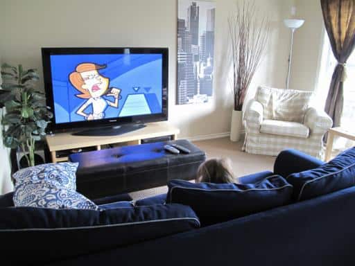 a kid watching tv at the living area
