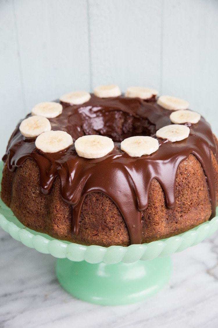 Close up of Banana Buttermilk Bundt Cake with Chocolate Glaze and slices of bananas on top