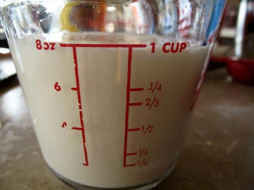 Pyrex measuring cup filled with milk